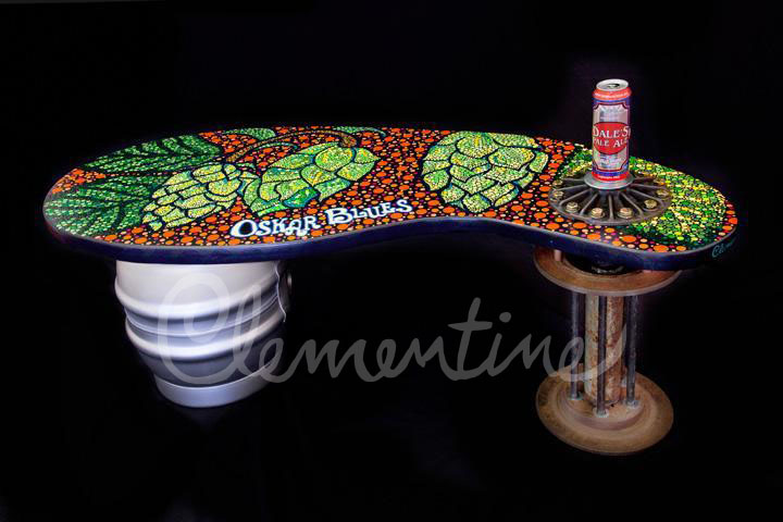 A bench made with a keg and topped with a dot mural of hops for Oskar Blues brewery.